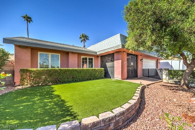 back of property featuring a yard and a garage