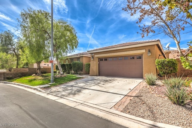 single story home featuring a garage, concrete driveway, a tile roof, and stucco siding