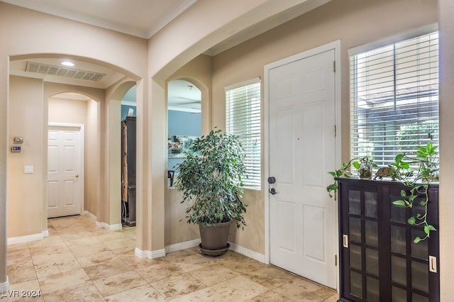 10909 Bramante Dr, Las Vegas, NV 89141 - entryway with crown molding, arched walkways, baseboards, and visible vents