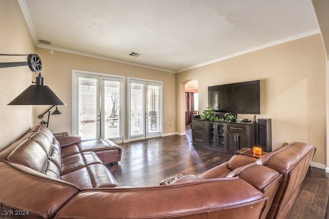 living room featuring baseboards, visible vents, arched walkways, dark wood finished floors, and crown molding