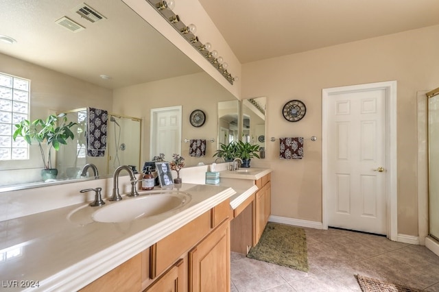 full bath featuring tile patterned floors, a sink, visible vents, and a shower stall