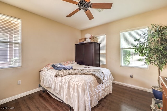 bedroom with a ceiling fan, baseboards, and dark wood-style flooring