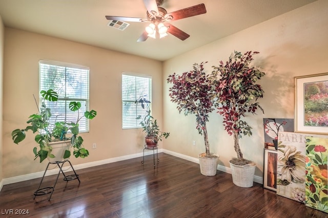 sitting room featuring dark wood-style floors, baseboards, visible vents, and ceiling fan