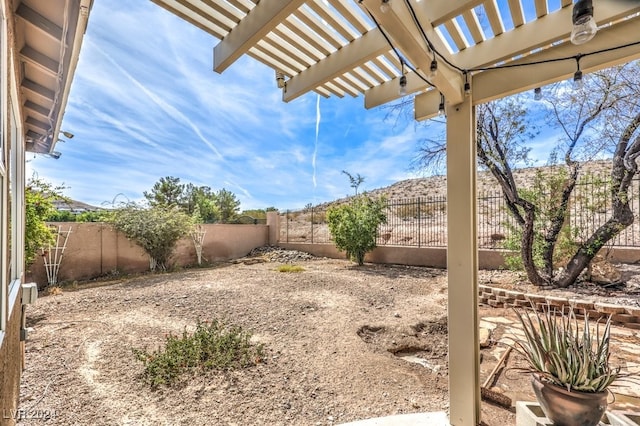 view of yard featuring a fenced backyard and a pergola