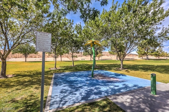 view of basketball court with a yard