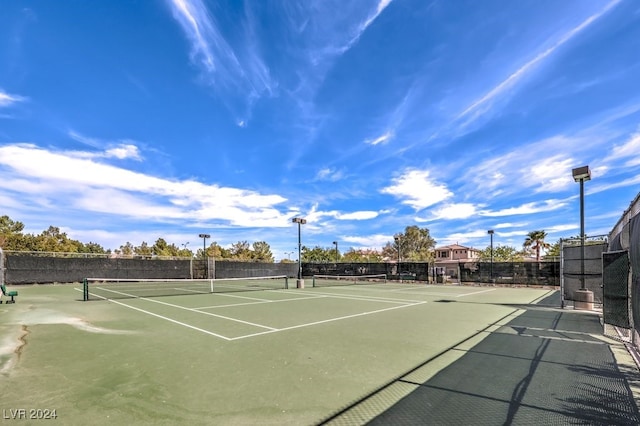 view of sport court featuring fence