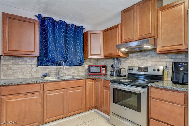 kitchen featuring light stone countertops, decorative backsplash, sink, electric stove, and light tile patterned floors