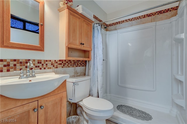 bathroom with toilet, vanity, decorative backsplash, and a shower with curtain