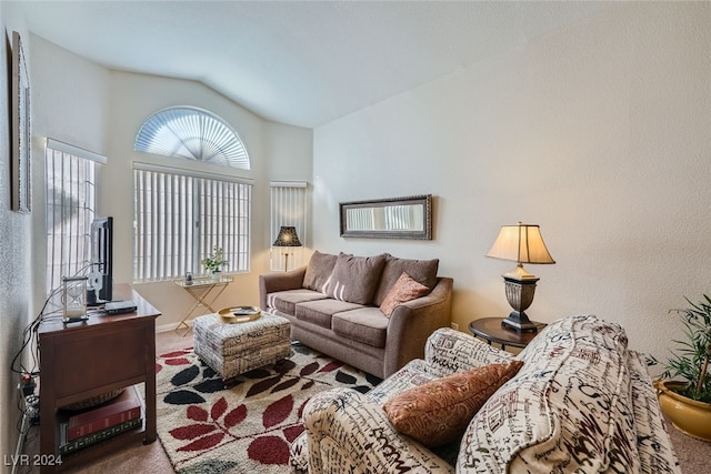 living room featuring carpet and vaulted ceiling