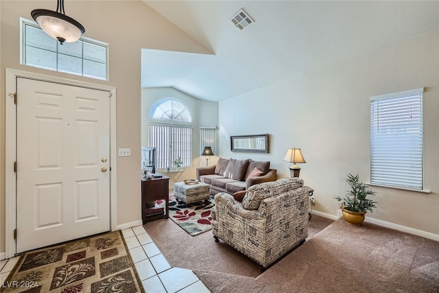 living room with tile patterned floors and lofted ceiling