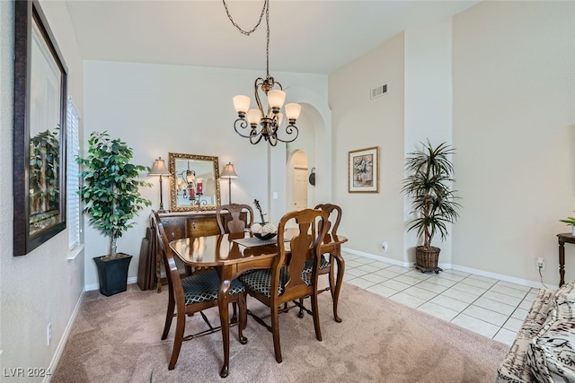 carpeted dining room with an inviting chandelier