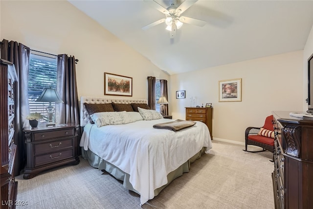 bedroom featuring ceiling fan, lofted ceiling, and light colored carpet