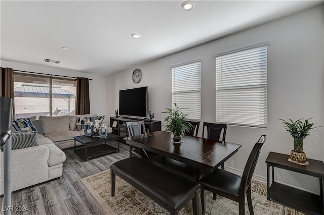 living room with recessed lighting, wood finished floors, visible vents, and baseboards