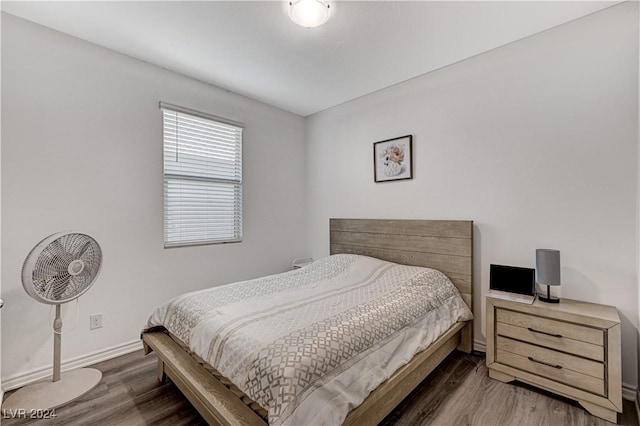 bedroom featuring baseboards and wood finished floors