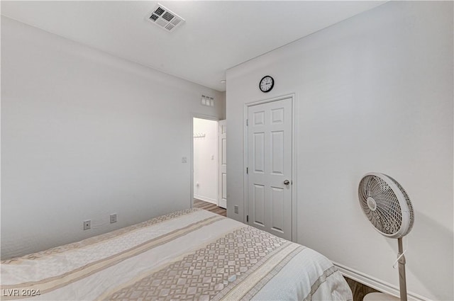 bedroom featuring baseboards and visible vents