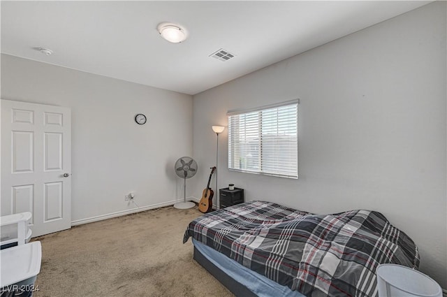 carpeted bedroom featuring baseboards and visible vents