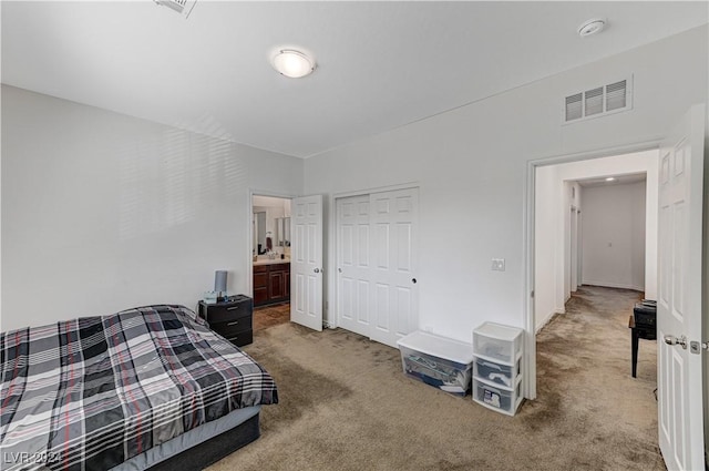 carpeted bedroom featuring a closet and visible vents