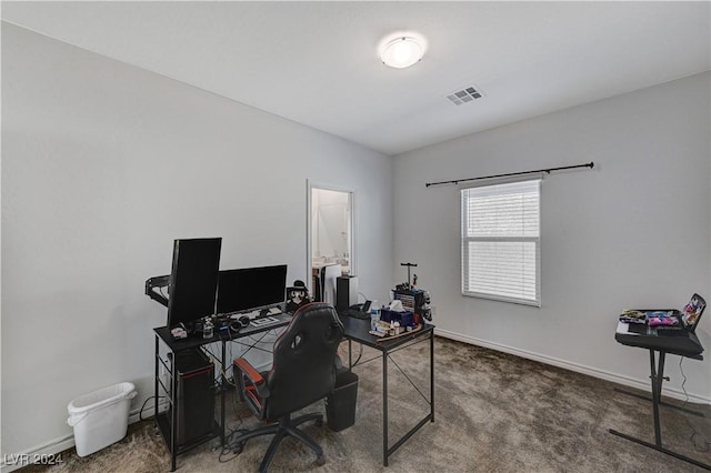 office space featuring carpet floors, visible vents, and baseboards