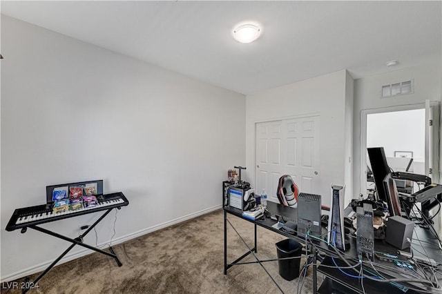 carpeted home office featuring visible vents and baseboards