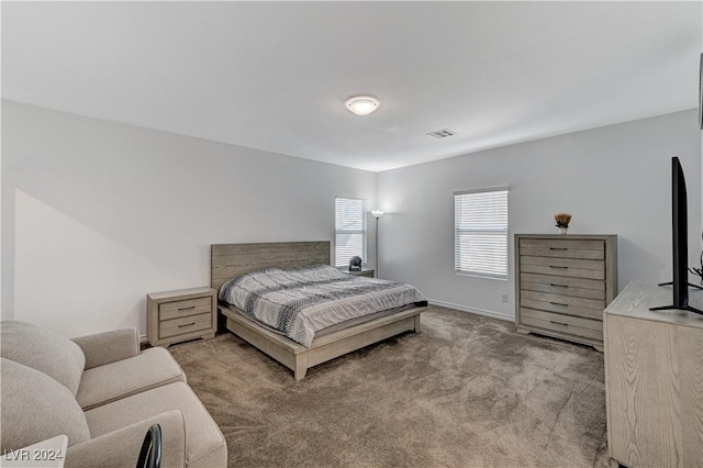 carpeted bedroom with baseboards and visible vents