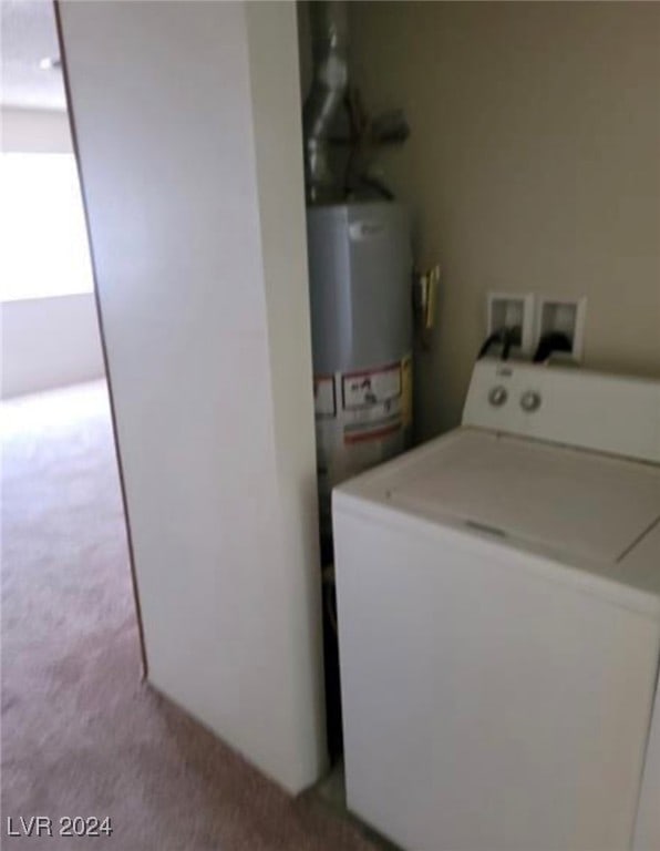 laundry room with light carpet, gas water heater, and washer / dryer