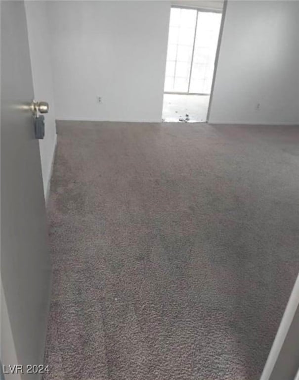 empty room featuring dark carpet