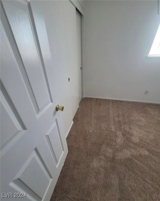 unfurnished bedroom featuring dark carpet