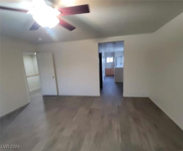 unfurnished room featuring ceiling fan and dark wood-type flooring