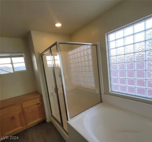 bathroom featuring separate shower and tub