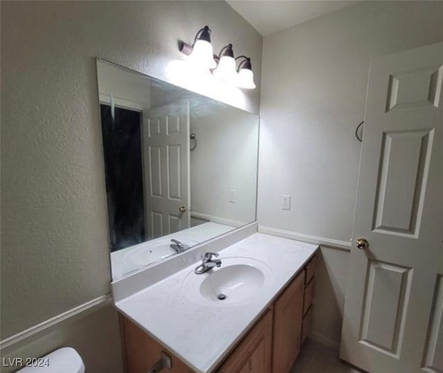 bathroom featuring vanity and toilet