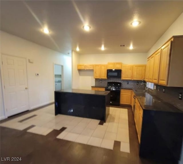 kitchen featuring light tile patterned flooring, tasteful backsplash, light brown cabinetry, sink, and black appliances