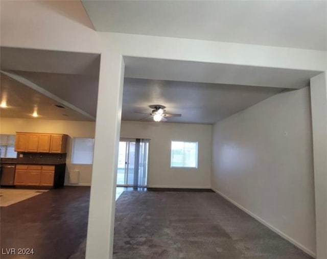 unfurnished living room with dark carpet and ceiling fan