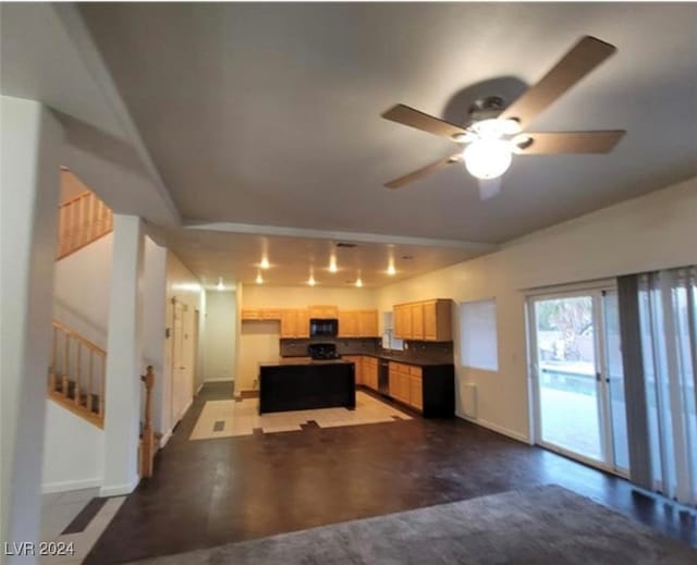 kitchen featuring ceiling fan, light brown cabinets, and a kitchen island