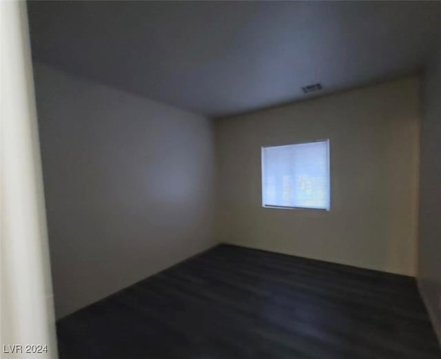 empty room featuring dark wood-type flooring