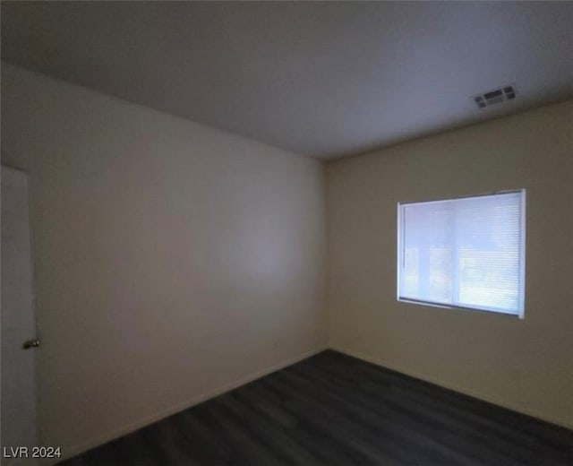 spare room with dark hardwood / wood-style floors