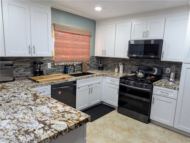 kitchen featuring white cabinets, black dishwasher, double oven range, and backsplash