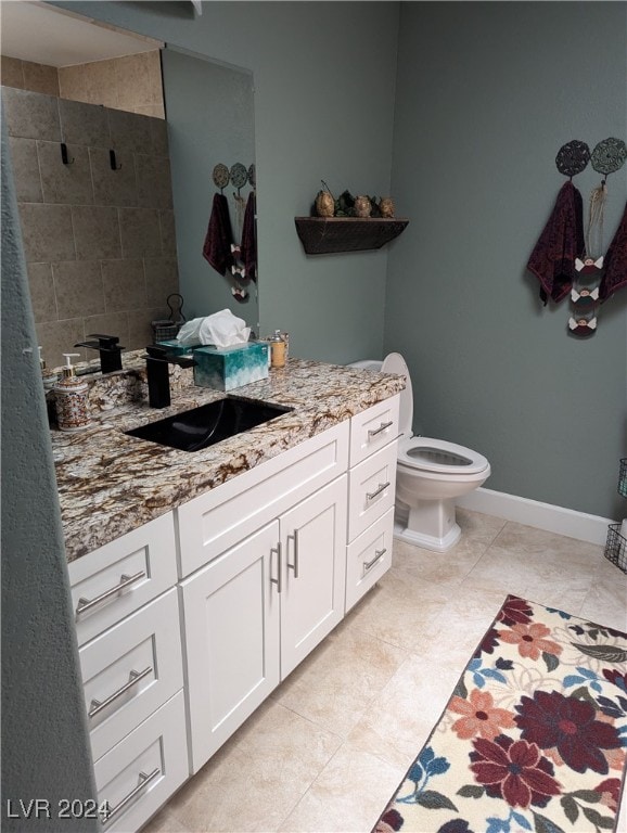 bathroom featuring tile patterned floors, vanity, and toilet