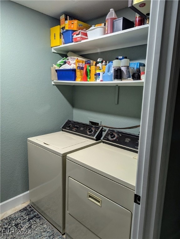 laundry room with washing machine and dryer and tile patterned floors