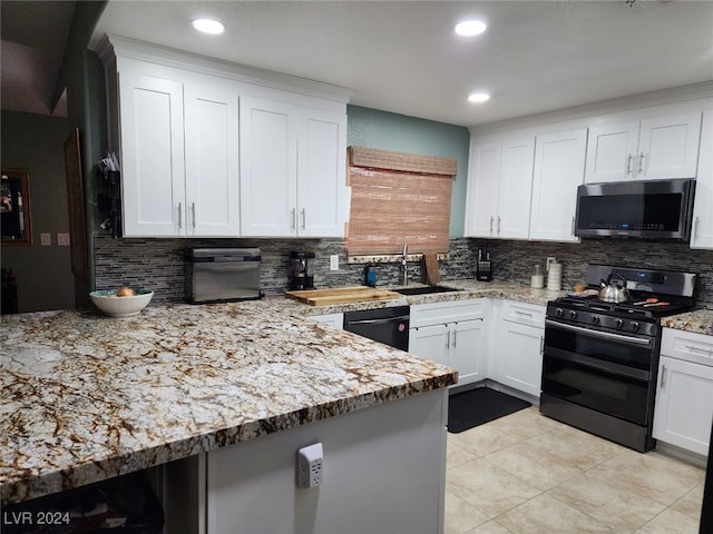 kitchen featuring decorative backsplash, sink, range with two ovens, dishwasher, and white cabinets