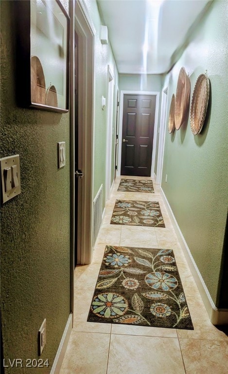 hall featuring light tile patterned flooring