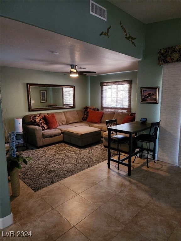 tiled living room with ceiling fan