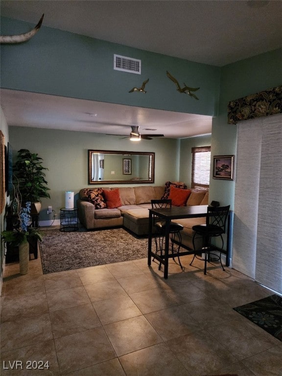 tiled living room featuring ceiling fan