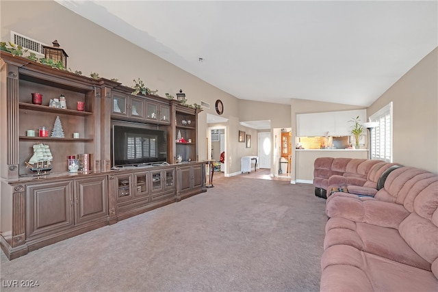 living room featuring vaulted ceiling and carpet floors