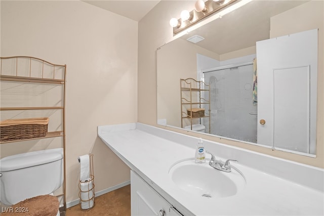 bathroom with vanity, toilet, and a shower with shower door