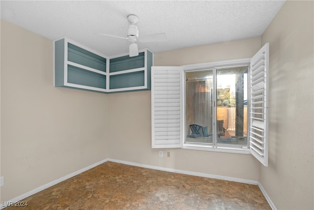 empty room featuring ceiling fan and a textured ceiling