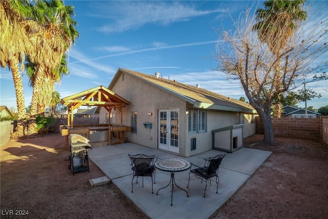 rear view of property with a gazebo, french doors, and a patio