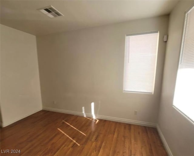 empty room featuring dark hardwood / wood-style flooring