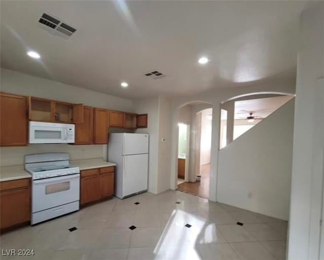 kitchen featuring light tile patterned flooring, ceiling fan, and white appliances