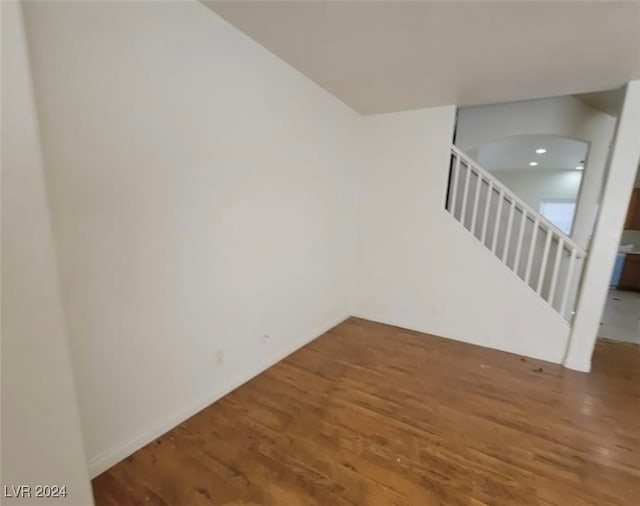 spare room with wood-type flooring