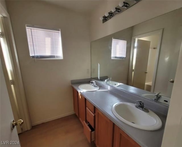 bathroom featuring vanity, shower / bath combination, hardwood / wood-style flooring, and a healthy amount of sunlight